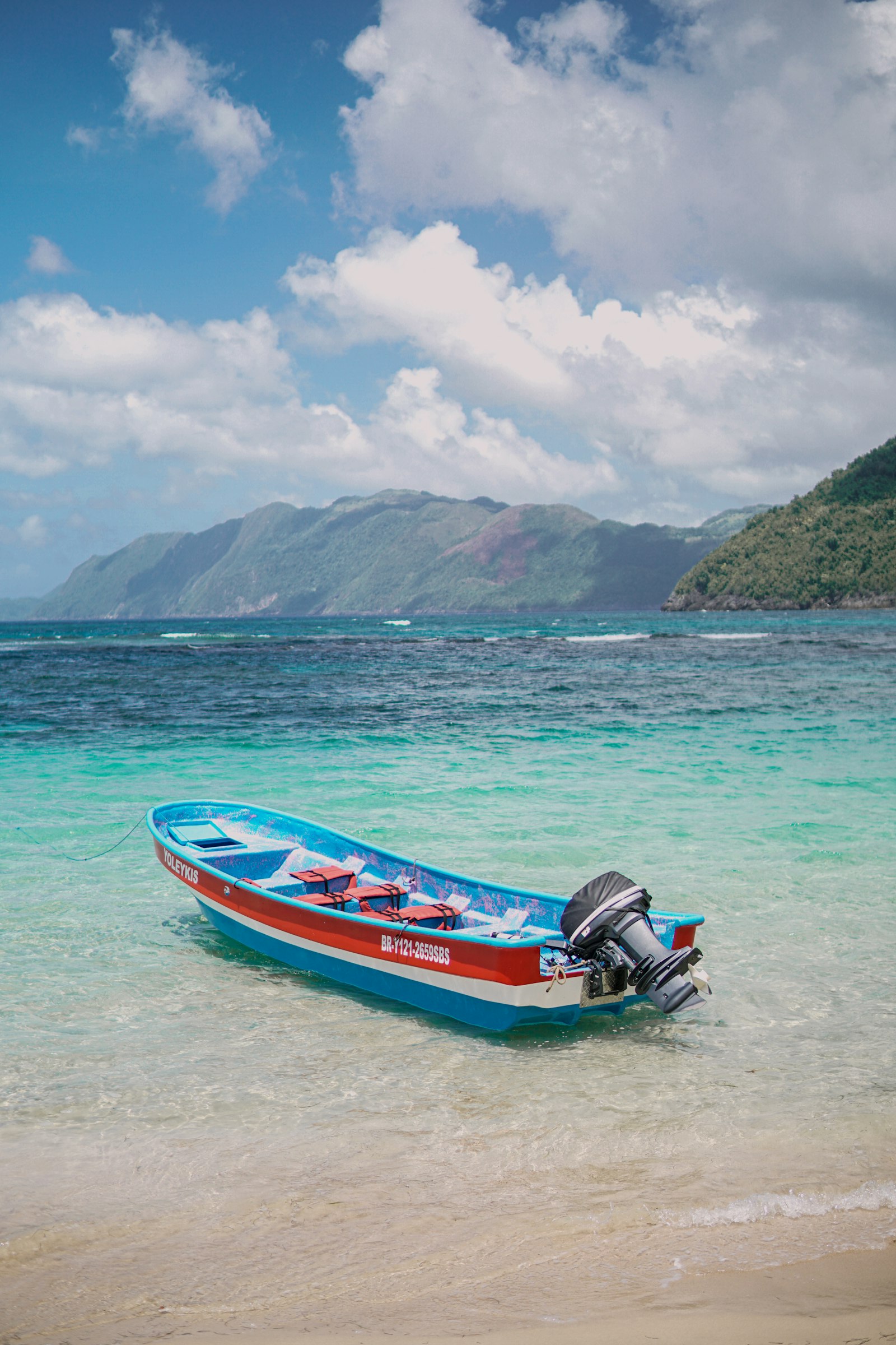 A wooden fishing boat drawn up on the sand in Samaná